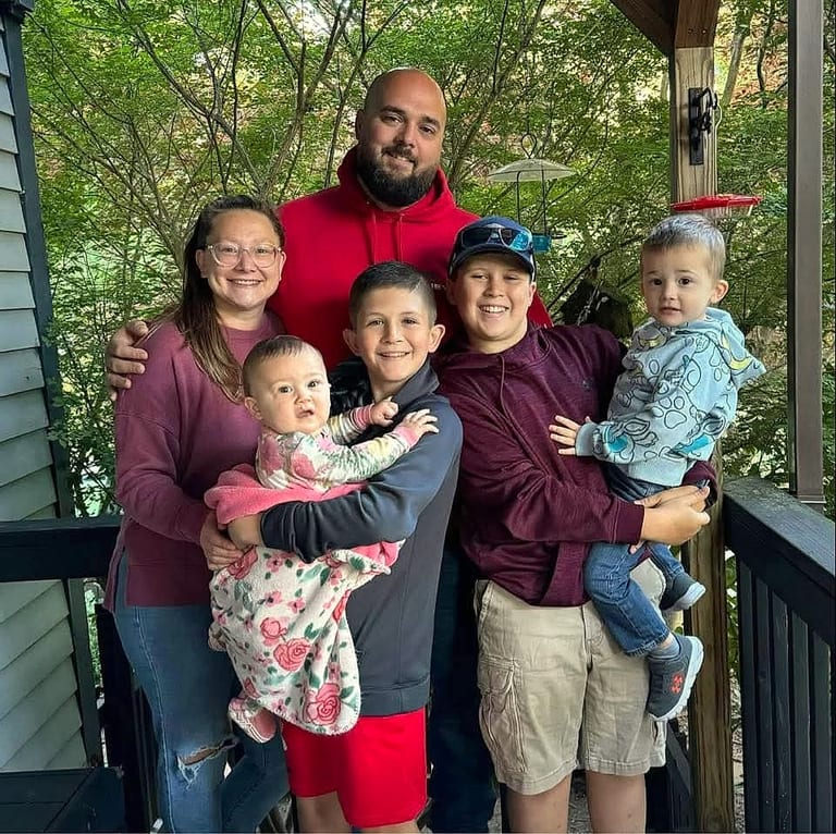 The Rainey family on their porch — Brian and Ashley with Wyatt, Lilah, Cameron, and Blake