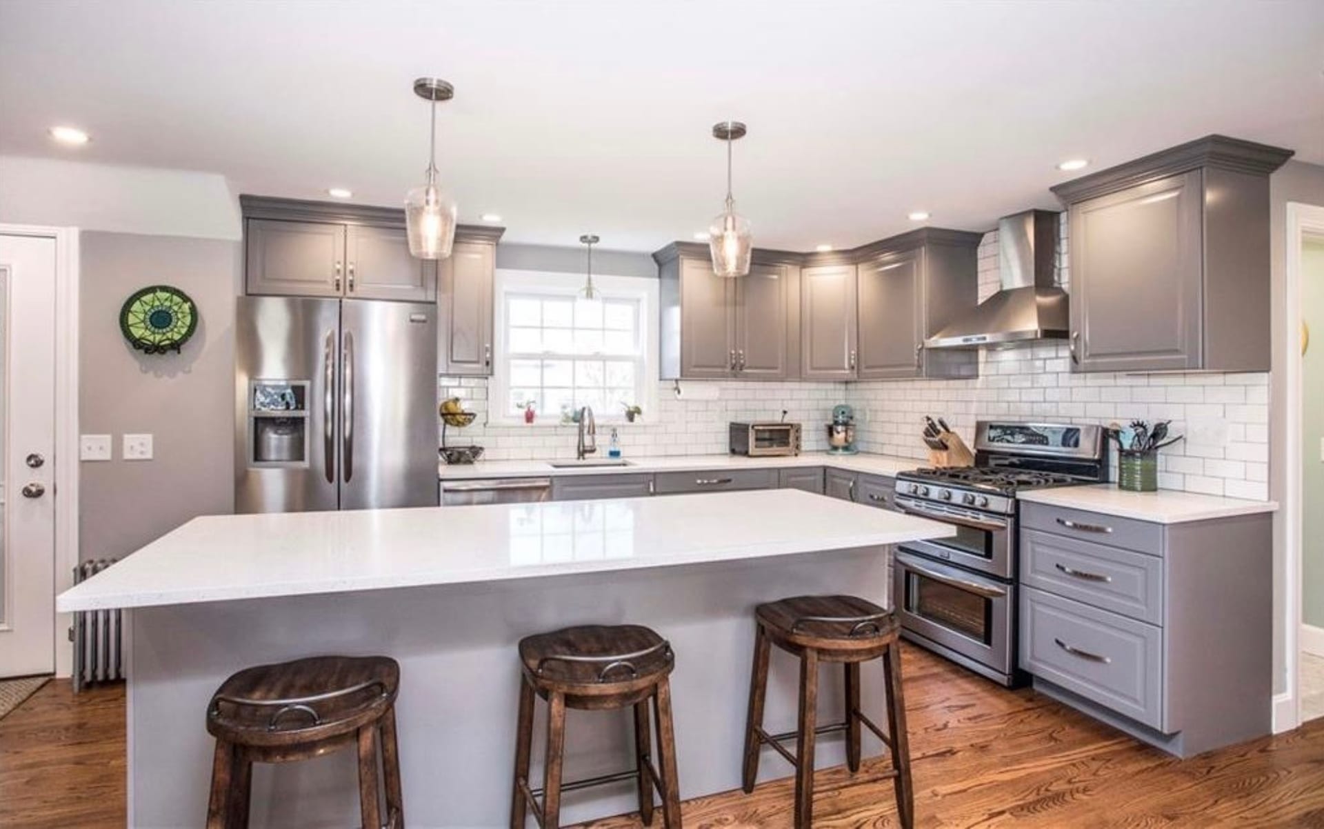 Kitchen island seating detail with pendant lighting